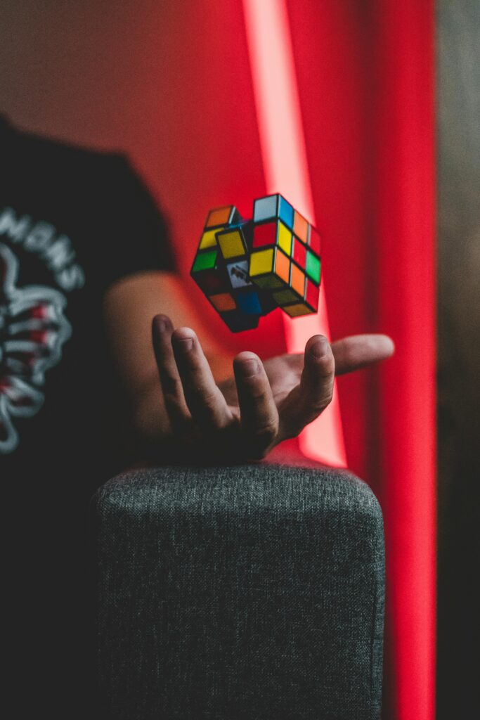 pexels-photo-2875617-2875617 Rubik's Cube levitating over a hand with vibrant backdrop, creating a sense of whimsy and intrigue.