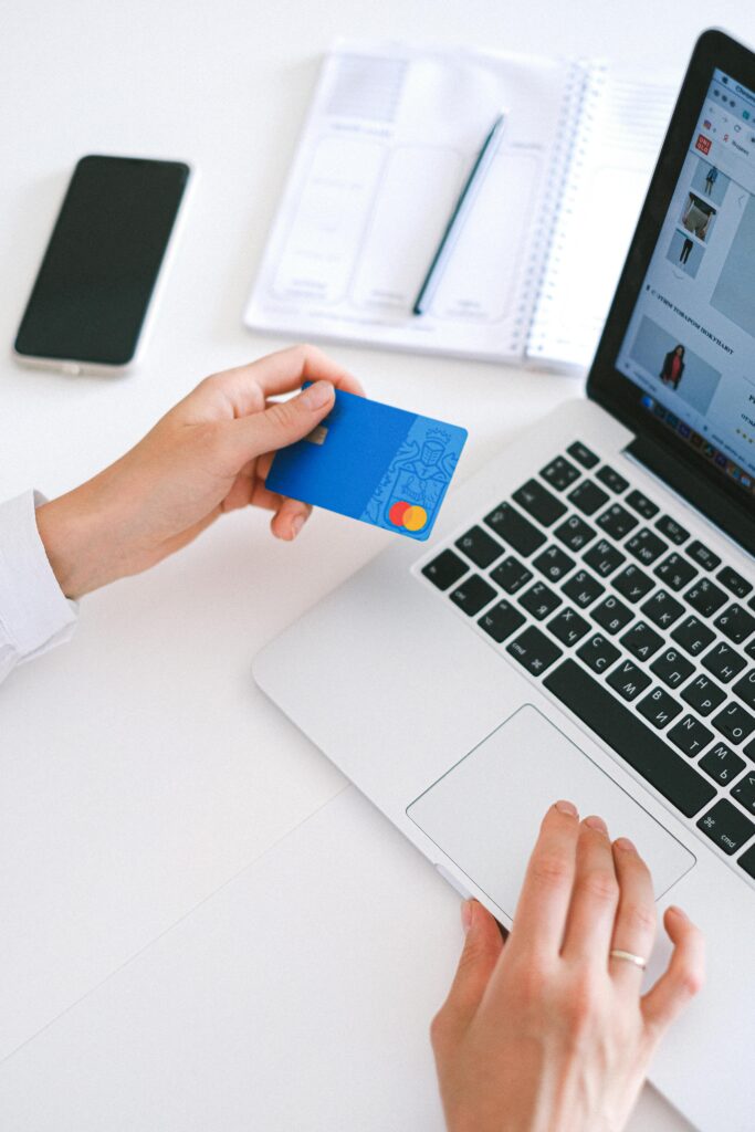 pexels-photo-4482900-4482900 Person making an online purchase with a credit card on a laptop, showcasing modern ecommerce technology.